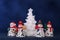 Four snowmen and white xmas tree