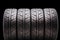 Four sports tires for the summer season on a black background, isolate. for passenger cars , tuning and spare parts