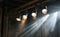 four spotlights on a stage with light source