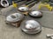 four stainless steel bowls, with various other metal objects and equipment scattered around