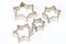 Four star shaped Christmas cookie cutters over white