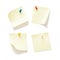 Four sticky notes with push pins