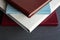 Four stylishly designed photobooks with leather covers, white, burgundy, brown and blue, of different thicknesses