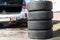 Four summer tyres are next to opened trunk of suv car, seasonal tire change