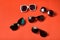 Four sun various glasses on live coral background. Travel concept