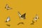 Four swallowtail butterflies in flight on fortuna gold background 3d illustration