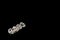 Four swarovski beads. Diamond, crystal beads. Shining. Copy space. Black background. Horizontal image