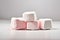 Four sweet marshmallows isolated on cream background
