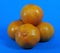 Four tangerines in a bunch with a blue background