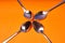 Four teaspoons laid out on an orange background