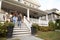 Four teen girlfriends walking down front steps of house