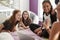 Four teen girls in bedroom looking at smartphone, close up