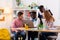 Four teenagers feeling cheerful and positive while studying together