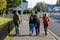 Four teenagers walking down a street with two of them hugging