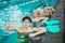 four teenagers wearing swimming goggles with showing muscle on hands biceps