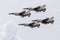 Four Thunderbirds flying in formation