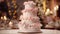 Four-tiered pink and white wedding cake decorated with rose flowers on table on party restaurant background. Wedding baked sweet