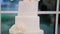 Four tiered white wedding cake in restaurant