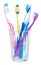 Four toothbrushes and interdental brush in glass