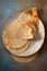 Four tortillas on a plate, ready to be served