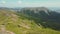 The four tourists standing on the mountain top. Hiking in the mountains. Aerial view of the picturesque Carpathian