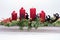 Four traditional red advent candles with christmas decoration