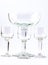 Four transparent elegant crystal glasses for cocktails on a white background