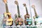 Four ukeleles on display behind a glass panel