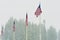 Four US Flags wave in falling snow