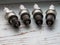 Four used car spark plugs on the wood