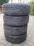 Four used car summer tires with wheels stacked