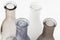 four vases for flowers of gray shades on a white background