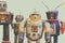 Four vintage rusted colorful tin toy robots