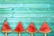 Four watermelon slice popsicles on blue wood background with copy space, summer fruit concept