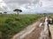 Four-wheel drive safari vehicle driving on wet pothole road with dark cloud at Serengeti in Tanzania, Africa