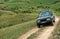 Four-wheel drive SUV car crossing mountain road