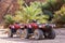 Four wheeled all terrain vehicle quad in the desert against the backdrop of palm trees and stone rocks in Egypt Dahab South Sinai