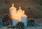 Four white Christmas Candles burning.