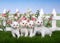 Four white kittens in a flower garden