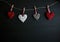 Four white and red hearts on black wooden table. Valentines, spring background. Mock up with copyspace. happy mothers day