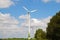 Four wind turbines against a sunny sky. Horizontal frame.