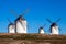 Four windmills in field