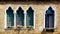 Four windows in arch shape and ancient decay brick wall