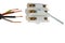 Four wired copper electric cable and plastic white cable joint with brass sockets and allen key screws for fastening, white backgr