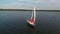 Four women in red clothes enjoying party on sailing boat