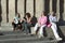 Four women relax in sunlight of old Barcelona in Barri Gotic area, the Gothic Quarter, Spain