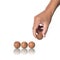 Four wood balls with human hand on white background.