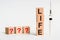 Four wooden blocks with LIFE text of concept. The abbreviation Life formed by wooden blocks on a white table. Next to it is a