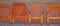 Four wooden chairs sitting side by side abstract color