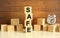 Four wooden cubes stacked vertically on a brown background form the word SAFE.